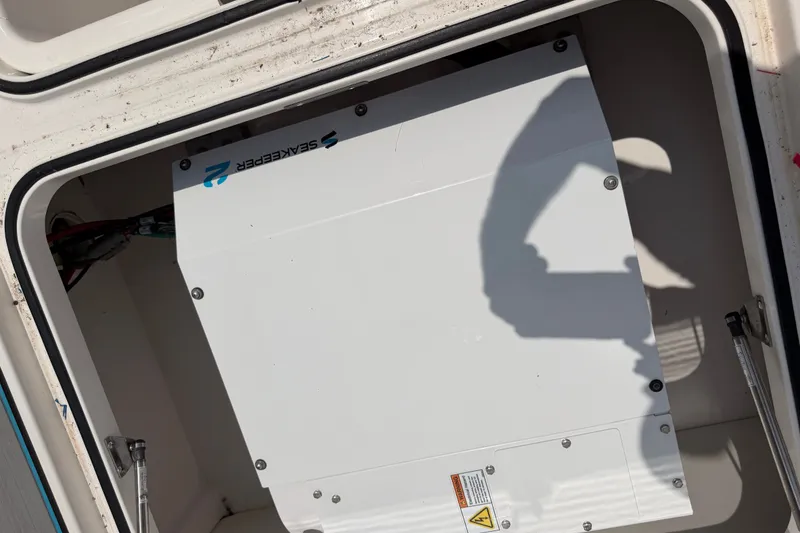Slide: The Image of Seakeeper system installed in a 2021 Caymas 341 CC boat compartment. - 63