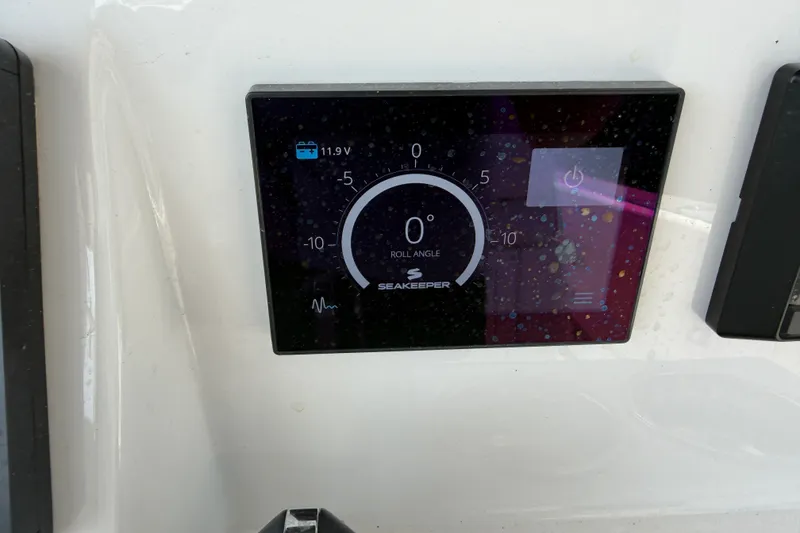 Slide: The Image of Seakeeper control panel on 2021 Caymas 341 CC boat, displaying roll angle and voltage. - 45