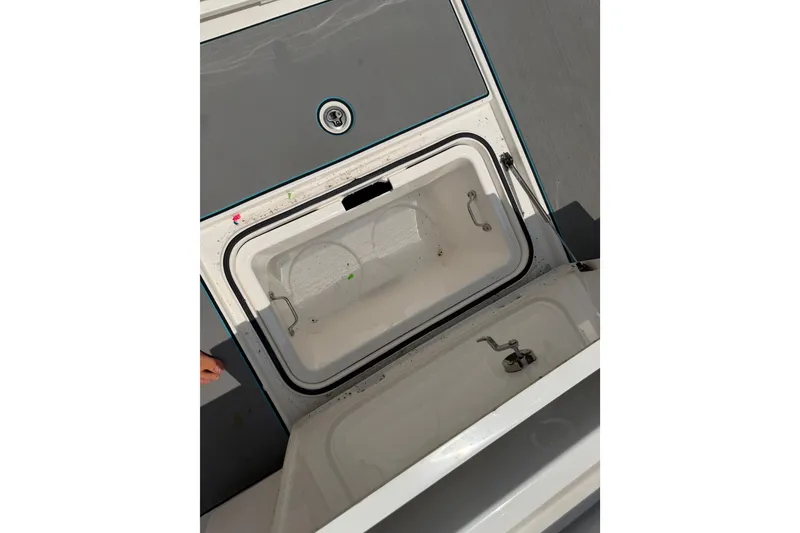 Slide: The Image of Open storage compartment on 2021 Caymas 341 CC boat deck. - 56