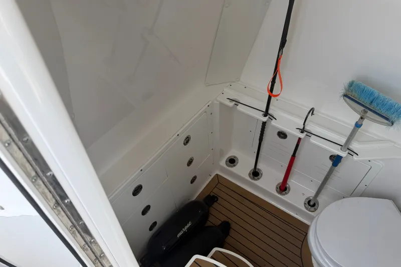 Slide: The Image of 2021 Caymas 341 CC boat interior with storage area and cleaning tools. - 46