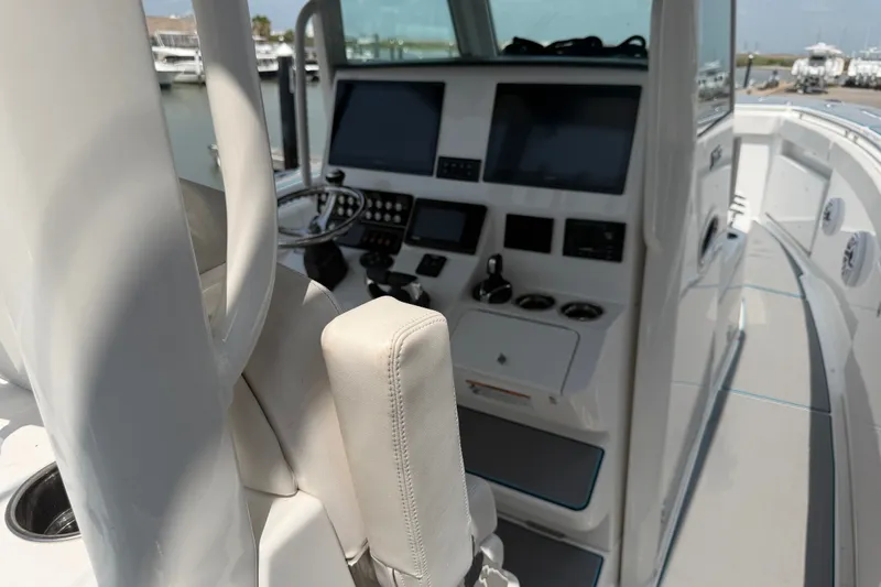 Slide: The Image of 2021 Caymas 341 CC boat cockpit with modern controls and navigation screens. - 15