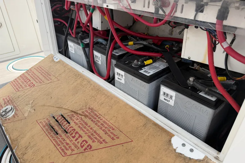 Slide: The Image of Battery compartment of 2021 Caymas 341 CC boat with AGM batteries and wiring. - 58