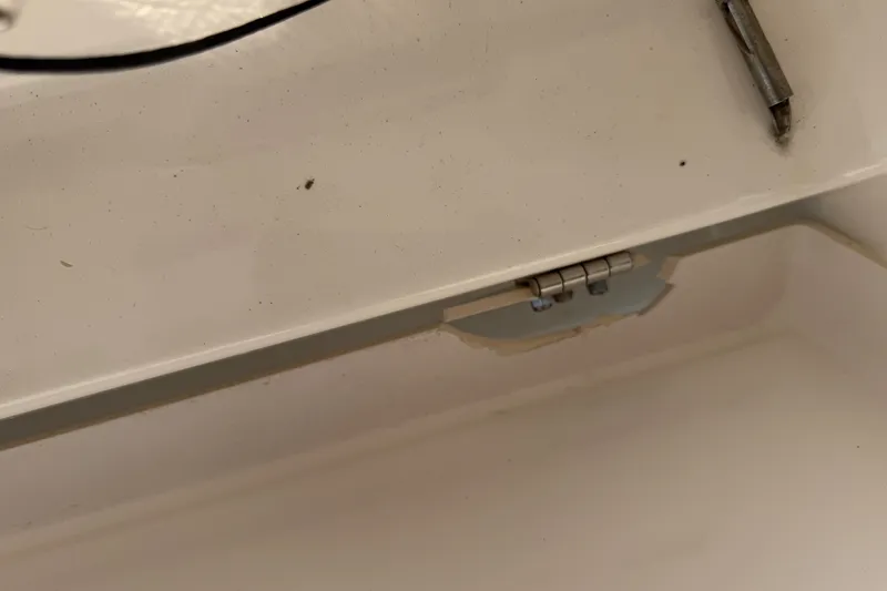 Slide: The Image of Close-up of a hinge on a 2021 Caymas 341 CC boat interior. - 33