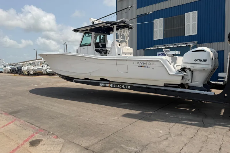 Slide: The Image of 2021 Caymas 341 CC boat on trailer at Surfside Beach, TX, with Yamaha engine. - 2