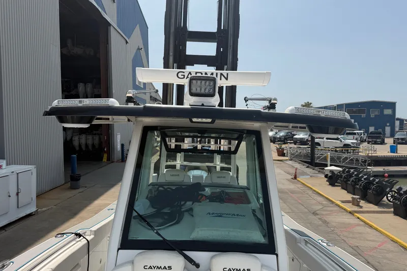 Slide: The Image of 2021 Caymas 341 CC boat with Garmin equipment at a marina dock. - 30