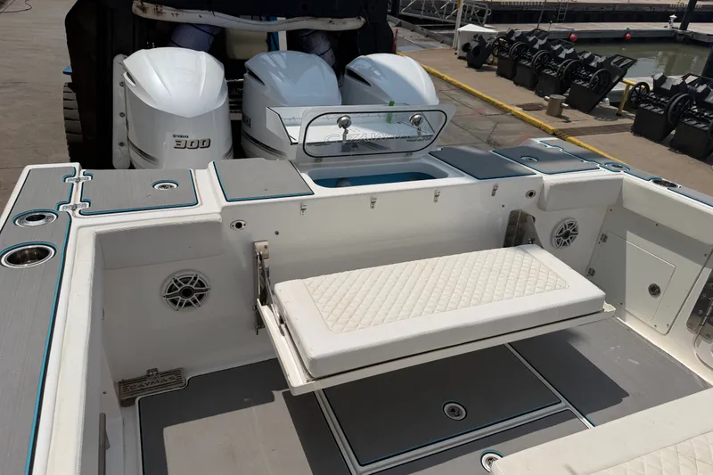 Slide: The Image of 2021 Caymas 341 CC boat with Yamaha 300 engines, featuring a foldable bench seat. - 16