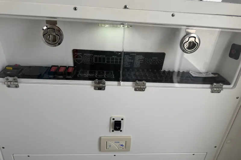 Slide: The Image of Control panel of a 2021 Caymas 341 CC boat with switches and indicators. - 40