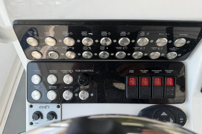Slide: The Image of Control panel of a 2021 Caymas 341 CC boat with various switches and buttons. - 47