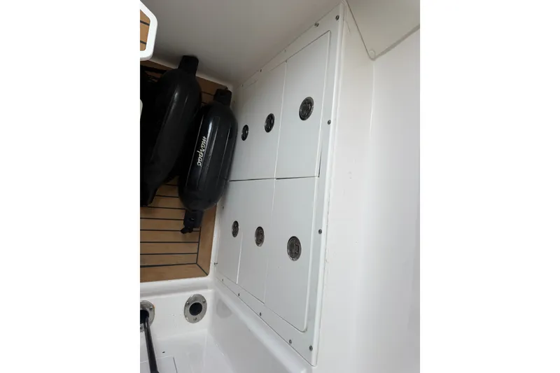 Slide: The Image of 2021 Caymas 341 CC boat storage compartment with black fenders. - 38