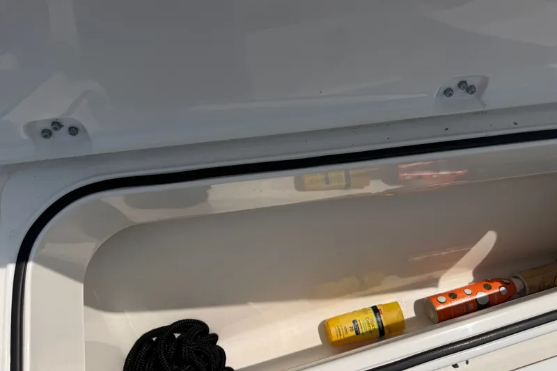 Slide: The Image of Storage compartment of 2021 Caymas 341 CC boat with rope and sunscreen. - 23