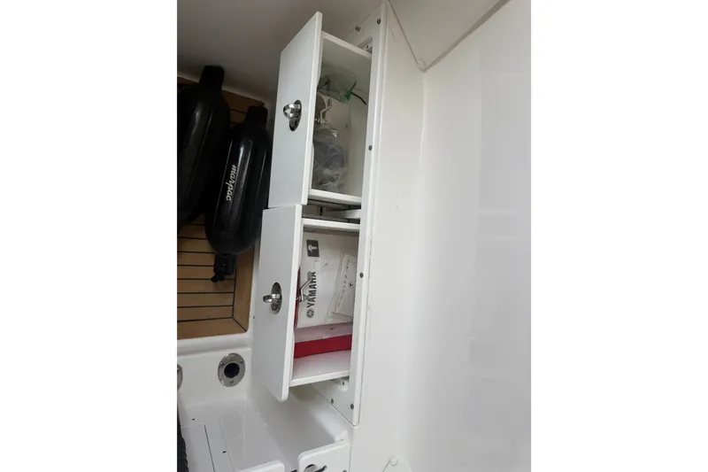 Slide: The Image of Storage compartments on a 2021 Caymas 341 CC boat, featuring Yamaha accessories. - 43