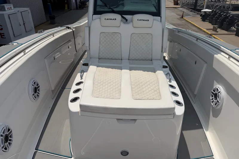 Slide: The Image of 2021 Caymas 341 CC boat interior with cushioned seating and cup holders. - 26