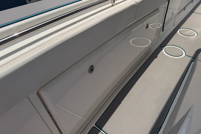 Slide: The Image of 2021 Caymas 341 CC boat deck with storage compartment and cup holders. - 29