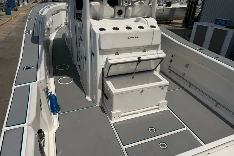 Slide: The Image of 2021 Caymas 341 CC boat interior with open storage compartment on deck. - 11