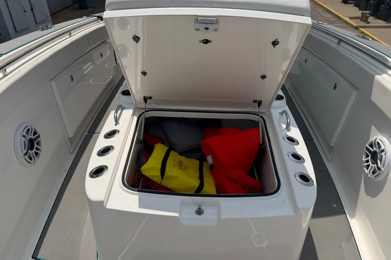 Slide: The Image of 2021 Caymas 341 CC boat storage compartment with life jackets and safety gear. - 31
