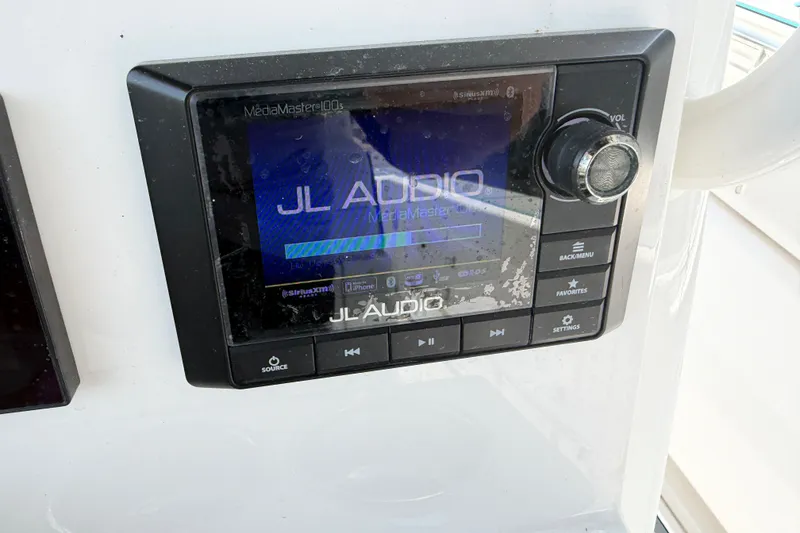 Slide: The Image of JL Audio MediaMaster 100s on 2021 Caymas 341 CC boat dashboard. - 62