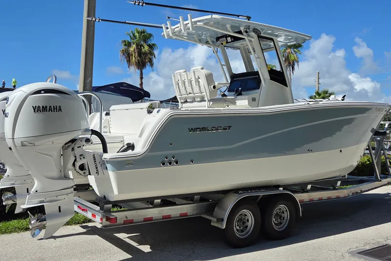 The Image of 2025 World Cat 260 CC-X boat on trailer with Yamaha engines, under clear blue sky. - 20