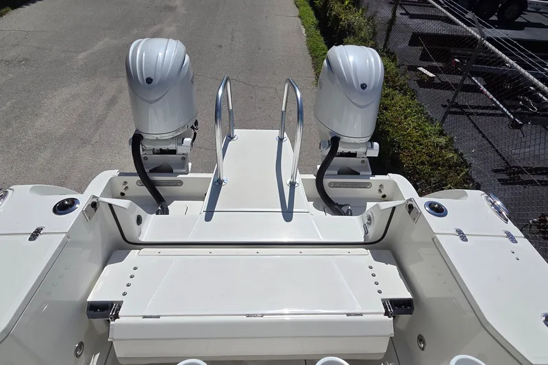 Slide: The Image of 2025 World Cat 260 CC-X boat with dual outboard motors, viewed from the rear. - 41