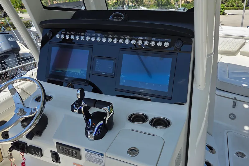 Slide: The Image of Helm of 2025 World Cat 260 CC-X boat with advanced navigation displays and controls. - 45