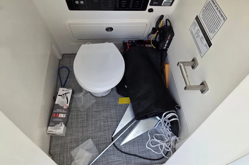 Slide: The Image of 2025 World Cat 260 CC-X boat interior with toilet, fire extinguisher, and anchor equipment. - 36