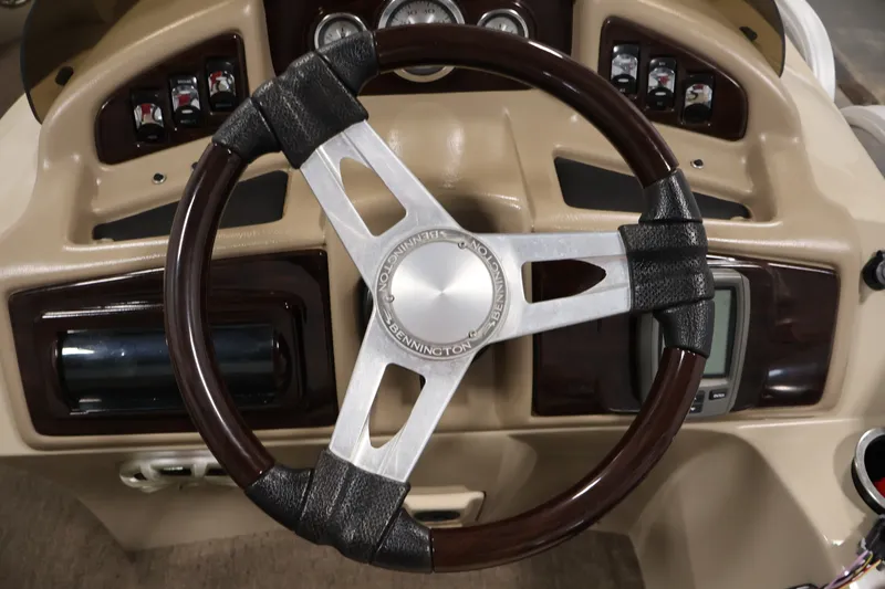 Slide: The Image of Steering wheel of a 2012 Bennington 2075 GS boat, featuring a classic design. - 25