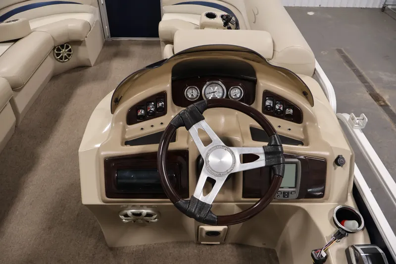 Slide: The Image of Interior view of a 2012 Bennington 2075 GS boat dashboard with steering wheel and controls. - 24