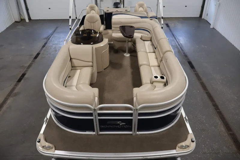 Slide: The Image of 2012 Bennington 2075 GS pontoon boat with beige seating in a garage setting. - 9