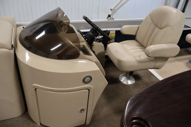 Slide: The Image of 2012 Bennington 2075 GS boat interior with beige captain's chair and control console. - 22