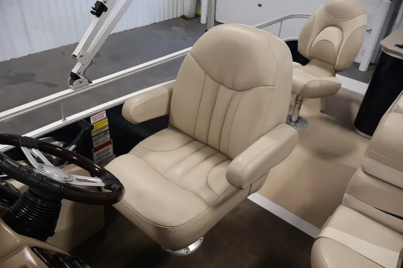 Slide: The Image of 2012 Bennington 2075 GS boat interior with beige captain's chair and steering wheel. - 33