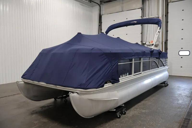 Slide: The Image of 2012 Bennington 2075 GS pontoon boat with blue cover in indoor storage. - 47