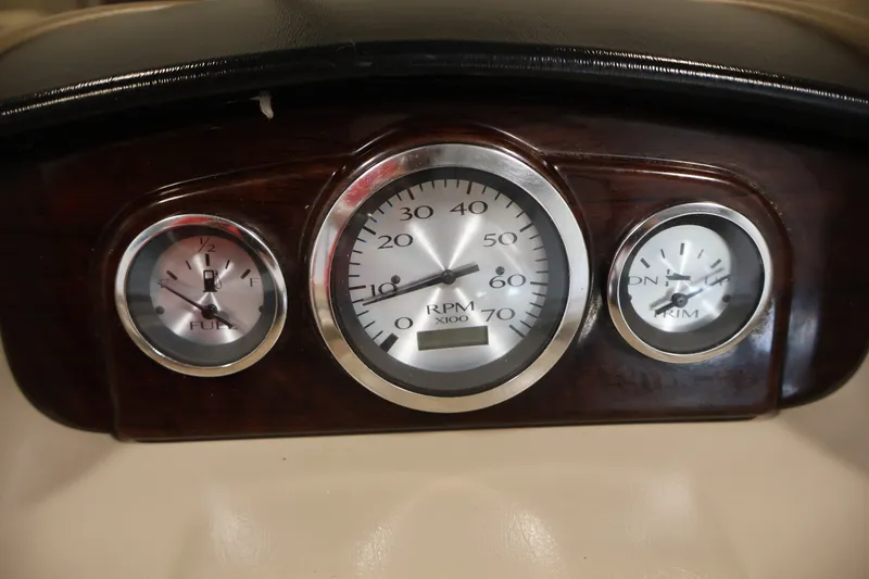 Slide: The Image of Dashboard gauges of a 2012 Bennington 2075 GS boat, showing fuel, RPM, and trim levels. - 26