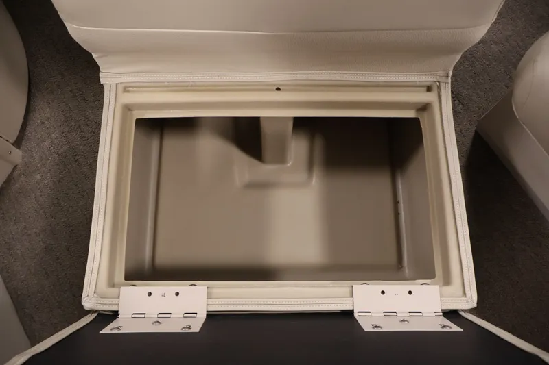 Slide: The Image of Storage compartment in a 2012 Bennington 2075 GS boat, featuring beige interior and sturdy hinges. - 21