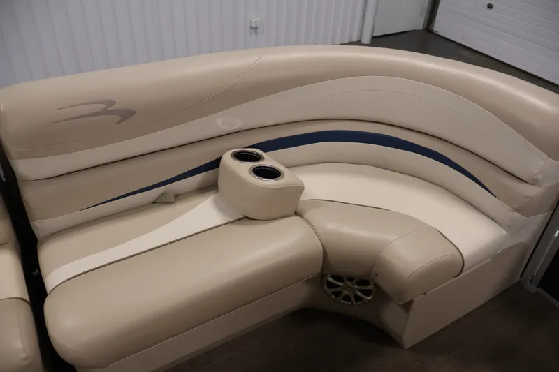Slide: The Image of 2012 Bennington 2075 GS boat seating with beige upholstery and cup holders. - 12