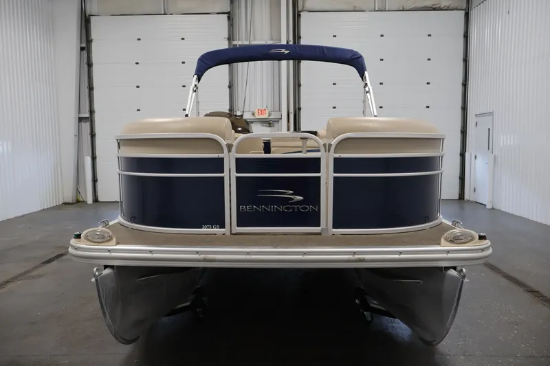Slide: The Image of 2012 Bennington 2075 GS pontoon boat in indoor storage facility. - 2