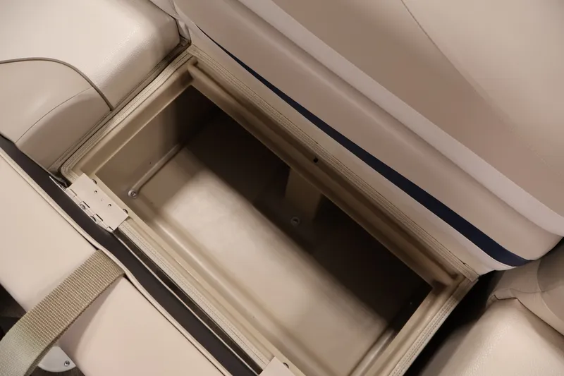 Slide: The Image of Storage compartment in a 2012 Bennington 2075 GS boat, featuring beige upholstery. - 35