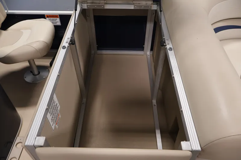 Slide: The Image of 2012 Bennington 2075 GS boat interior storage compartment with beige seating and chair. - 37