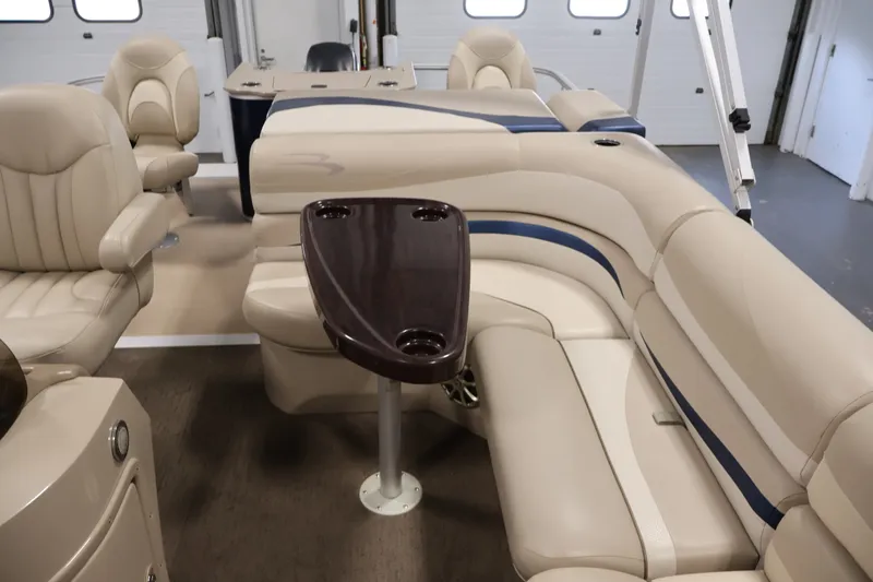Slide: The Image of Luxurious interior of a 2012 Bennington 2075 GS pontoon boat with plush seating and table. - 34