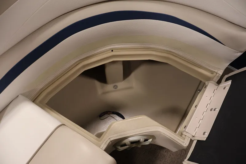 Slide: The Image of Interior storage compartment of a 2012 Bennington 2075 GS boat, featuring beige upholstery. - 14