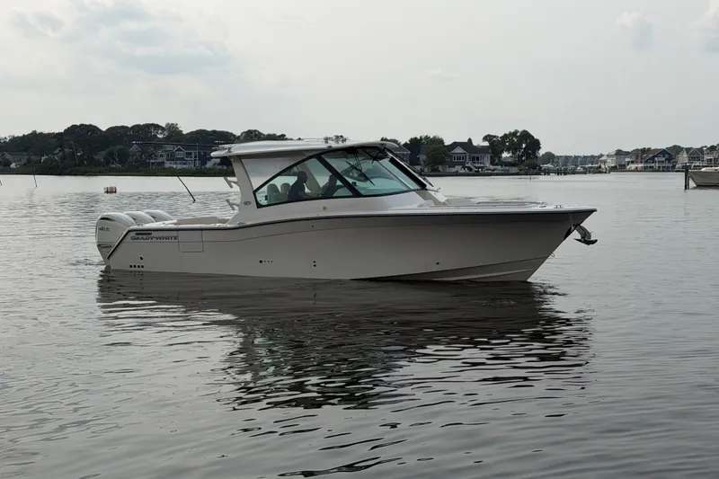 Slide: The Image of 2027 Grady-White Freedom 345 boat on calm water, side view. - 6