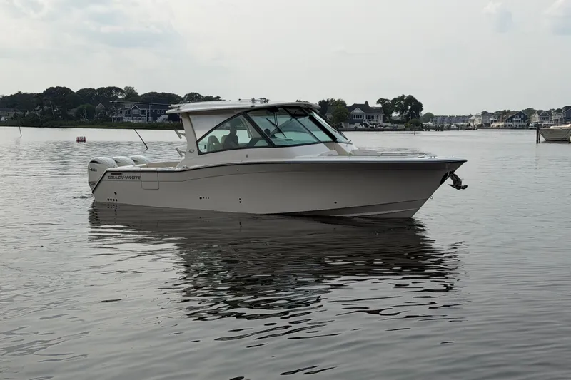 Slide: The Image of 2027 Grady-White Freedom 345 boat on calm water, showcasing sleek design and modern features. - 4