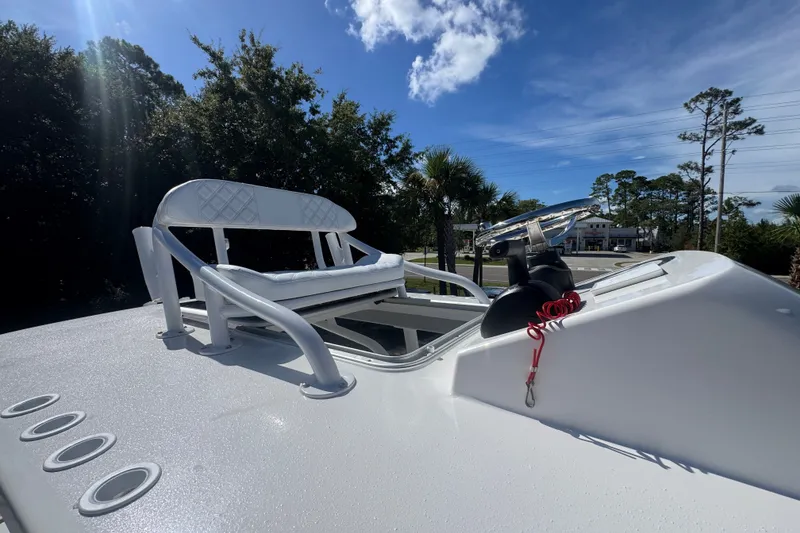 Slide: The Image of 2025 BlackJack 256 Coastal boat helm with seating, under a clear blue sky. - 25