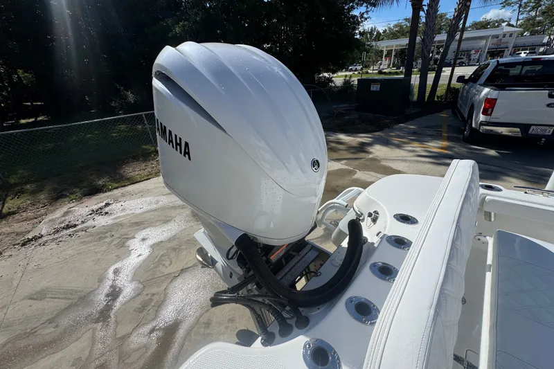 Slide: The Image of 2025 BlackJack 256 Coastal boat with Yamaha outboard motor in a sunny outdoor setting. - 43