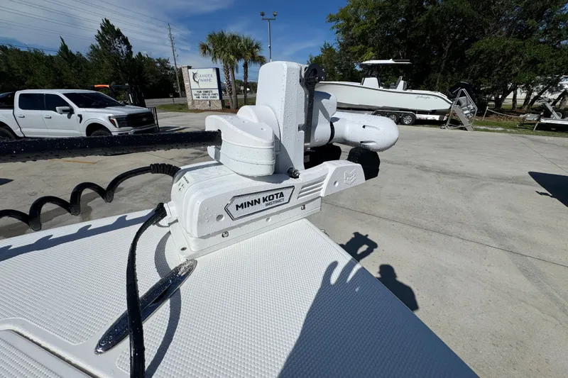Slide: The Image of Minn Kota motor on 2025 BlackJack 256 Coastal boat, parked outdoors. - 18