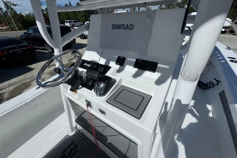 Slide: The Image of Center console of 2025 BlackJack 256 Coastal boat with steering wheel and controls. - 36