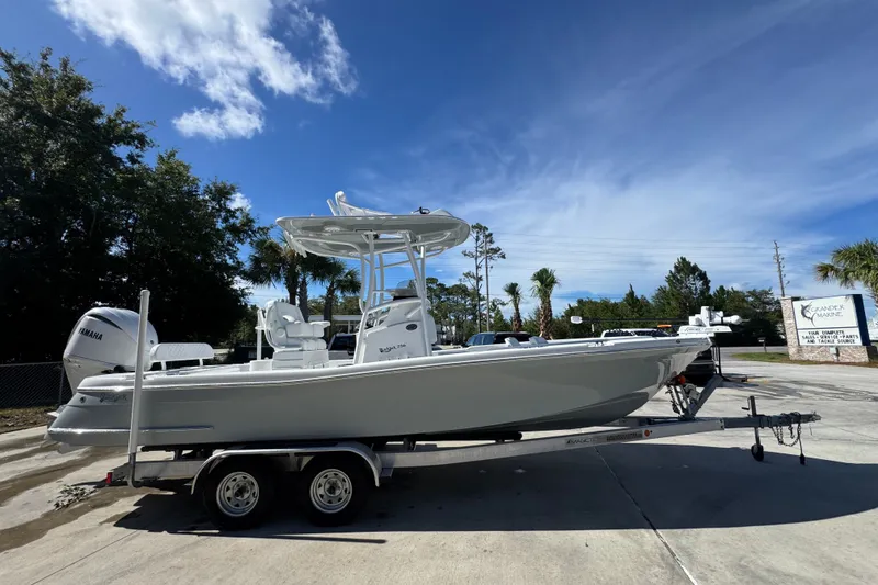 Slide: The Image of 2025 BlackJack 256 Coastal boat on trailer under clear blue sky. - 8