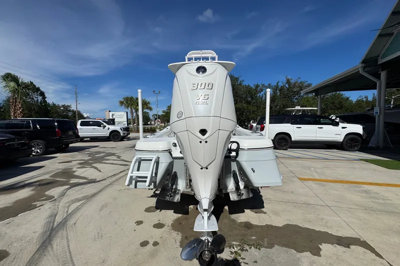 Slide: The Image of 2025 BlackJack 256 Coastal boat with powerful 300 V6 engine, parked outdoors. - 12