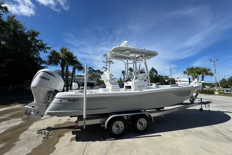 Slide: The Image of 2025 BlackJack 256 Coastal boat on trailer, featuring Yamaha engine, under clear blue sky. - 9