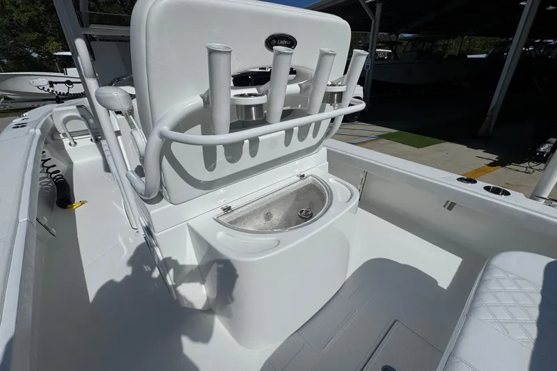 Slide: The Image of 2025 BlackJack 256 Coastal boat interior with rod holders and storage compartment. - 37