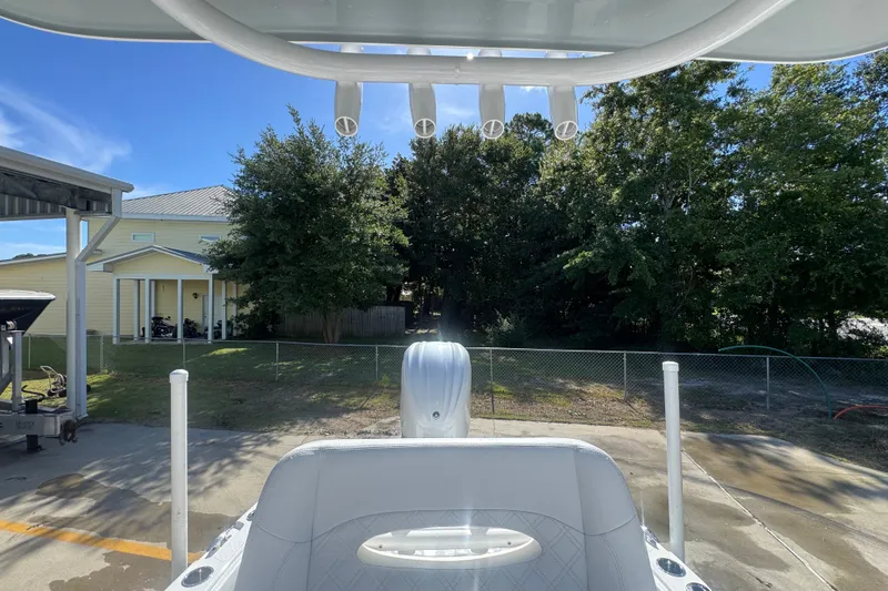 Slide: The Image of 2025 BlackJack 256 Coastal boat parked near a house with trees in the background. - 31