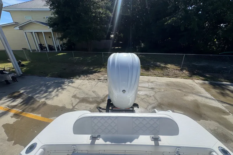 Slide: The Image of Rear view of 2025 BlackJack 256 Coastal boat with outboard motor in driveway. - 41